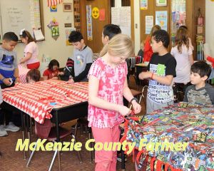 Watford City third graders make blankets for hospital patients near and far in essence of Valentine’s Day